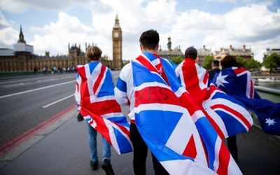 People walk to Westminster Bridge wrapped in Union flags in central London, the UK, on Sunday. Picture: AFP PHOTO/ODD ANDERSON