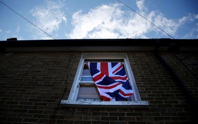 A British flag flutters in front of a window in London, the UK, after the vote to leave the European Union. Picture: REUTERS/REINHARD KRAUSE