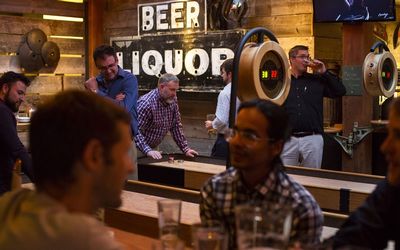 Patrons play shuffleboard and drink beer at Brave Horse Tavern in the South Lake Union neighborhood of Seattle, Washington, US, on Thursday, June 9, 2016. In 2010, Amazon.com Inc. moved to South Lake Union speeding the neighborhood's transformation into a vibrant business district. Photo: DAVID RYDER/BLOOMBERG