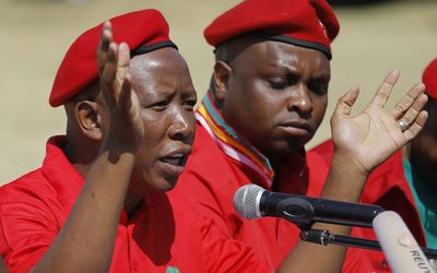 EFF leader Julius Malema addresses the media in Johannesburg on Wednesday while his deputy, Floyd Shivambu, looks on. He announced that his party would not go into political partnerships with either the ANC or the DA.
Picture: EPA 