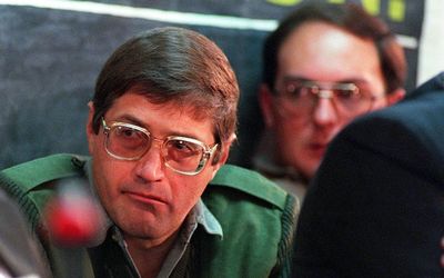 Eugene de Kock under guard in July 1998 at the Truth and Reconciliation Commission hearing dealing with his crimes. Picture: AFP PHOTO/WALTER DHLADHLA