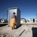 A woman inspects a newly installed enclosed toilet in Makhaza, Cape Town, in 2011. Picture: THE TIMES