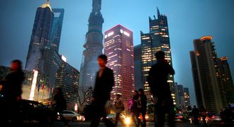 People walk along a busy street at Pudong financial district in Shanghai. Picture: REUTERS
