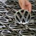 An employee holds an emblem for a Volkswagen Golf car in a production line at the Volkswagen headquarters in Wolfsburg, Germany, in this November 14 2008 file photo.  Picture: REUTERS