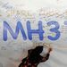 A woman writes a message of hope for the passengers of the missing Malaysia Airlines flight MH370 on a banner at Kuala Lumpur International Airport on Wednesday. Picture: REUTERS