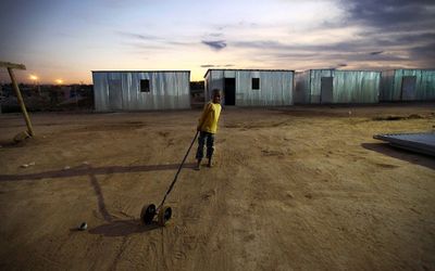 A young boy plays with his cart in the temporary housing settlement in Riemvasmaak, the poorest township in Oudtshoorn.  Picture: THE TIMES