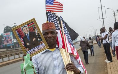 A hawker sells a picture of US President Barack Obama and US flags near  Kenyatta University in Nairobi, Kenya, on Sunday. Picture: AFP PHOTO/GEORGINA GOODWIN