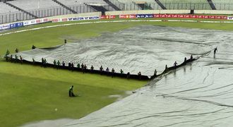 Bangladeshi ground staff cover the field as rain falls during the fourth day of the second Test between Bangladesh and SA at the Sher-e-Bangla National Cricket Stadium in Dhaka yesterday. Only 81.1 overs — out of 360 — have been bowled so far. Picture: AFP PHOTO/MUNIR UZ ZAMAN