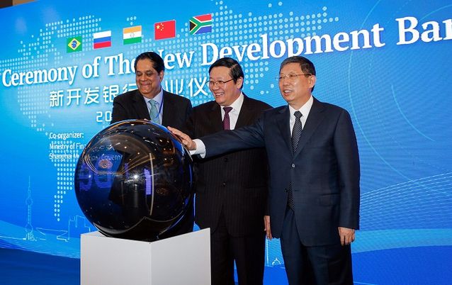 The president of the New Development Bank, Kundapur Vaman Kamath (left) of India, China’s Finance Minister Lou Jiwei and Shanghai’s mayor Yang Xiong, attend the opening ceremony of the bank in Shanghai on Tuesday. Picture: EPA/XING ZHE