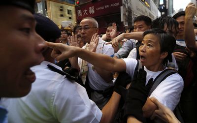 Protesters argue with police who have blocked part of a street from a mass protest to demand universal suffrage in Hong Kong on Tuesday. Picture: REUTERS