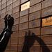 A mourner takes photos of a brick wall at the house of Nelson Mandela in Soweto on Saturday. Picture: REUTERS