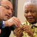 Then finance minister Trevor Manuel and Nelson Mandela look at the 90th-birthday R5 coin launched at the Nelson Mandela Foundation in 2008. Picture: HALDEN KROG