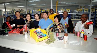 Uno CEO Judy Chen, centre, with staff and her parents, Jenny (left) and Mark Chen (right), founder members of Uno Sewing Machinery at the Johannesburg manufacturing plant.  Picture: FREDDY MAVUNDA