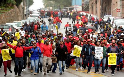 South African Municipal Workers Union members march towards City Hall in Nelson Mandela Bay municipality.  Picture: THE HERALD/MIKE HOLMES