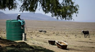 A farm worker sits on a water tank as he supplies his livestock with water at a farm outside Utrecht, a small town in the northwest of KwaZulu-Natal. Picture: REUTERS/SIPHIWE SIBEKO