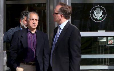 Ahmad Sheikhzadeh, centre, a consultant to the Iranian mission to the United Nations, leaves Brooklyn Federal Court in New York on Wednesday, March 23 2016. He is accused of charges related to sanctions violations, money laundering and tax matters. Picture: REUTERS